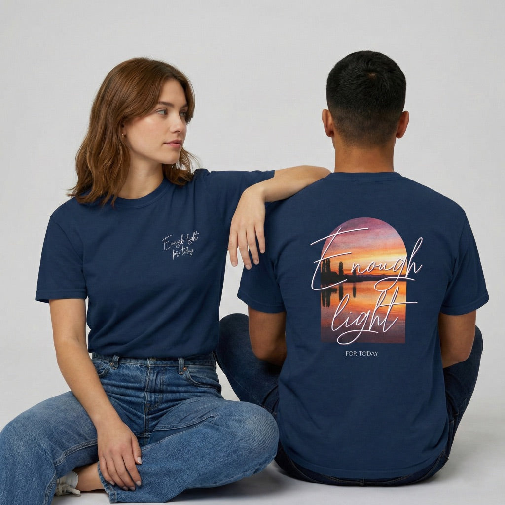 Model wearing the Enough Light For Today shirt showing the spiritual landscape design and navy premium fabric.