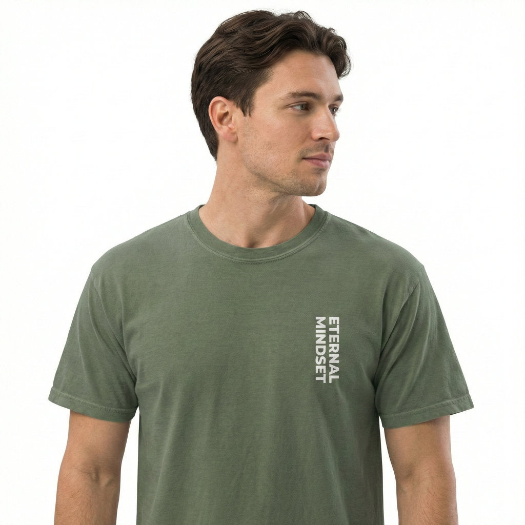Man wearing a green t-shirt with 'Eternal Mindset' text on a white background