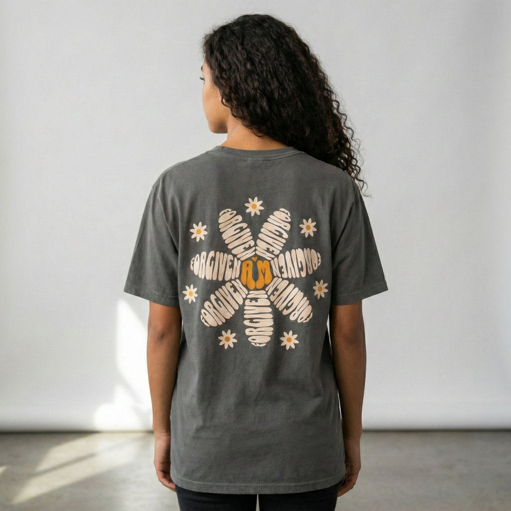 Person wearing a dark gray t-shirt with a floral design on the back against a plain background