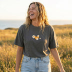Woman wearing I Am Forgiven Christian t-shirt with floral back print and heart front design