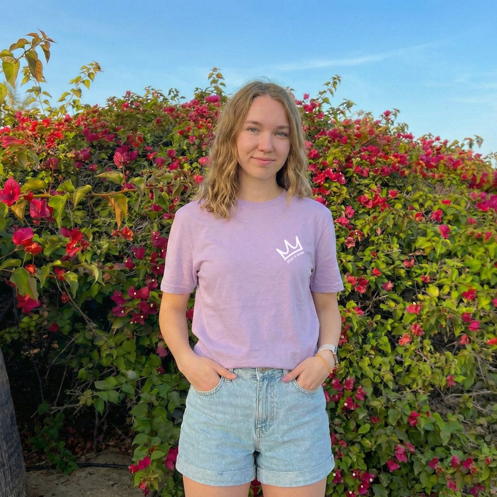 Female model wearing Jesus Is King Christian t-shirt front small crown design