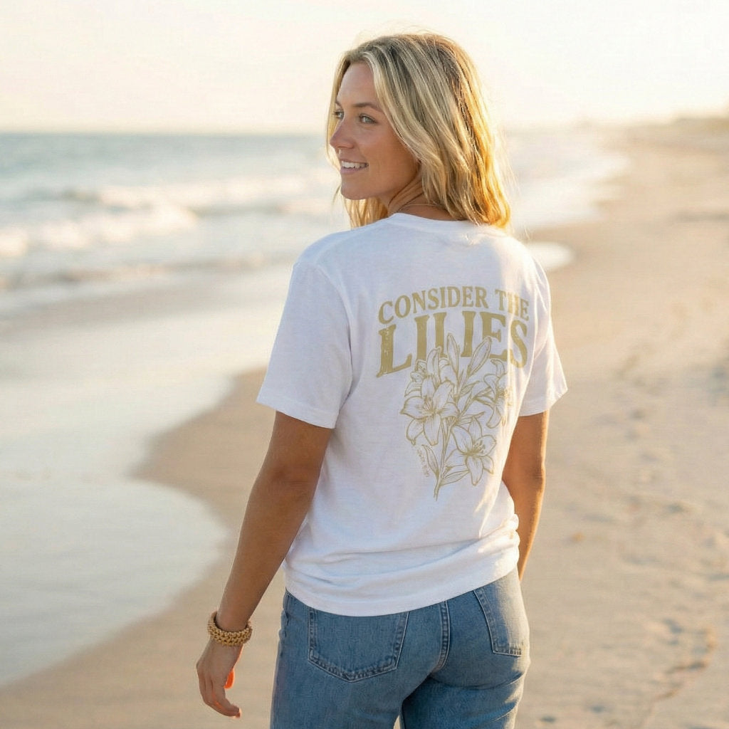 Minimalist floral Scripture t-shirt with Luke 12:27 reference design