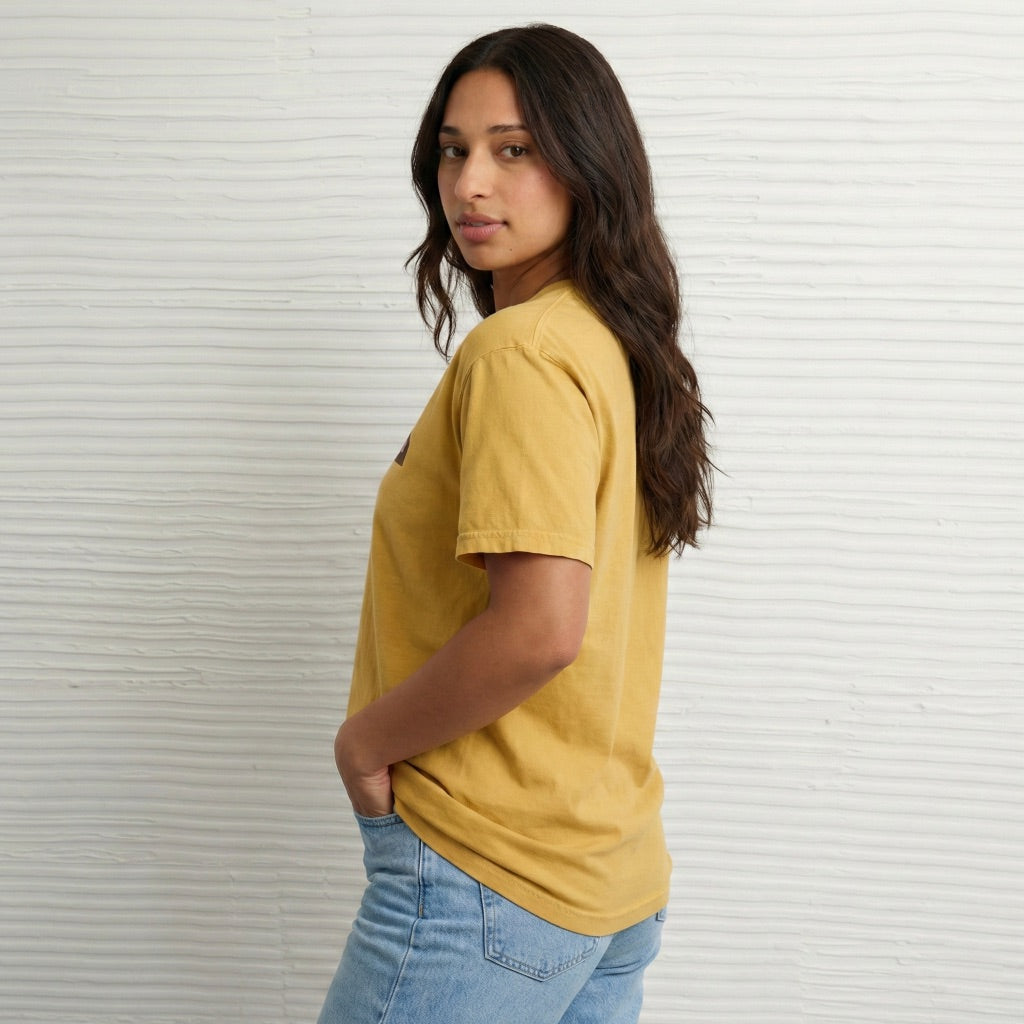 Model wearing gold New Every Morning unisex tshirt with pink retro graphic