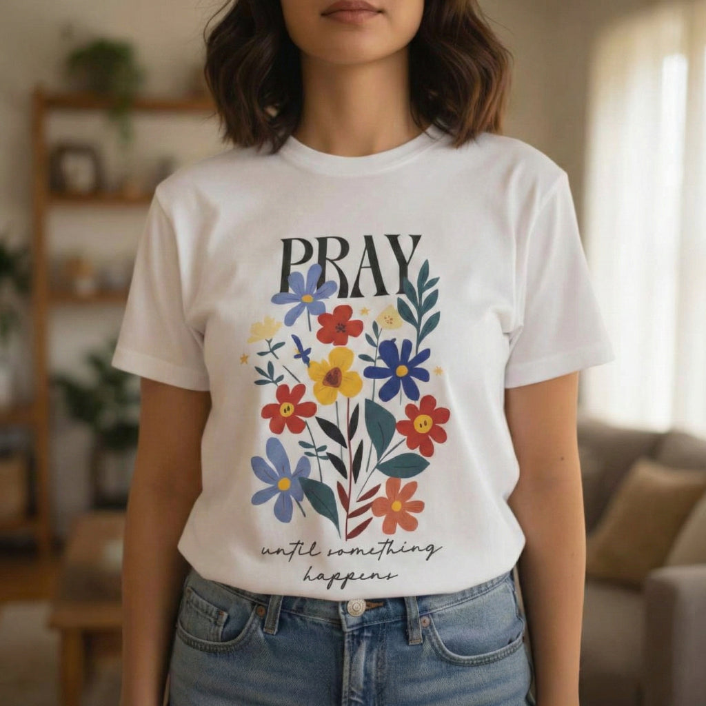Woman wearing Pray Until Something Happens Christian floral t-shirt front view white