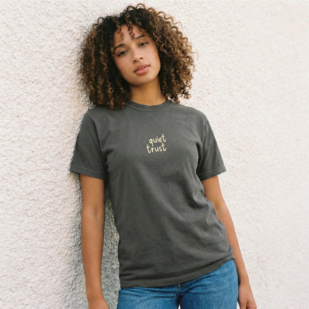 Front view of charcoal Way Is Made t-shirt with minimalist Quiet Trust logo on chest and premium cotton texture