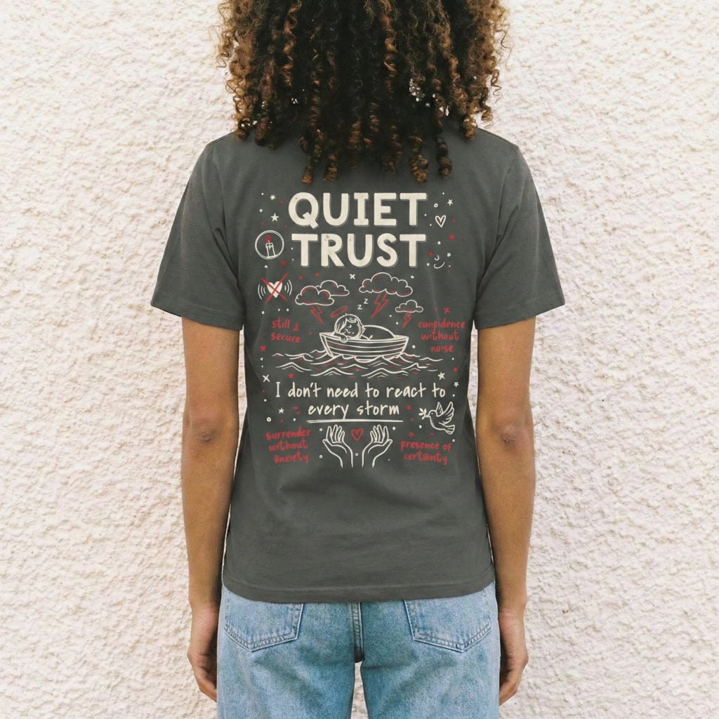 Back of charcoal Quiet Trust unisex t-shirt featuring Jesus sleeping in boat and I don't need to react to every storm text