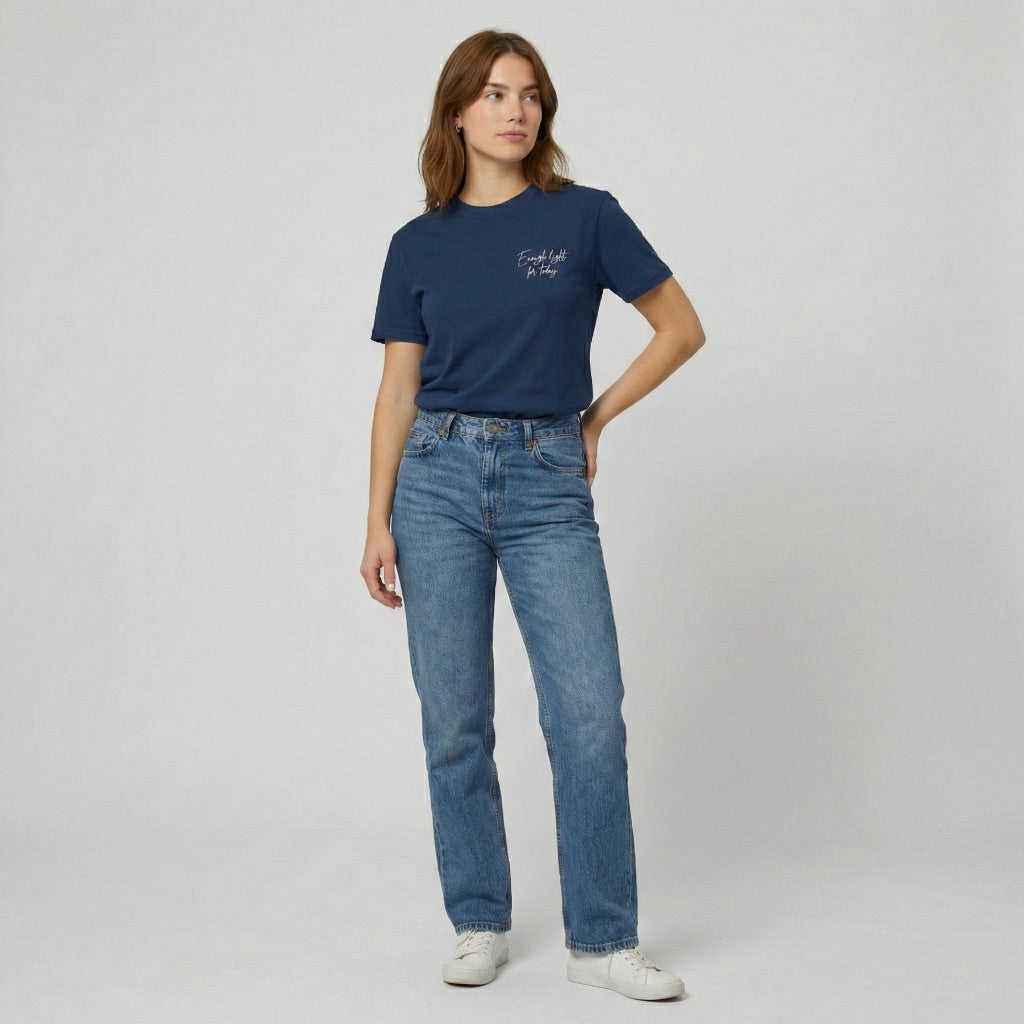 Close up of script font reading Enough Light For Today over a reflected sunset landscape on a navy tee.