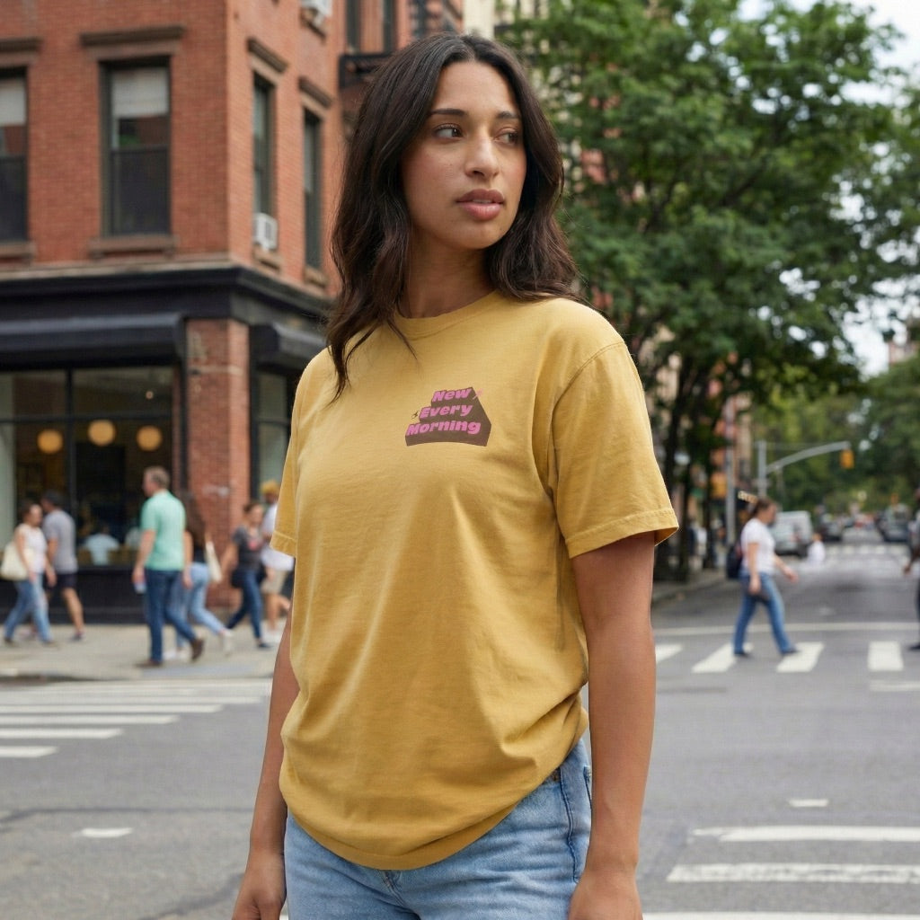 Lifestyle shot of gold New Every Morning tee styled for casual streetwear